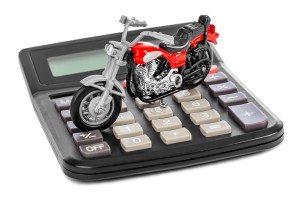 Calculator and toy motorbike isolated on white background
